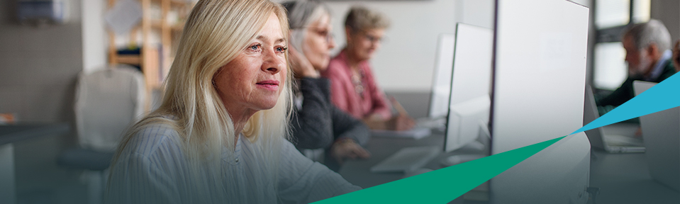 A blonde woman in an office with her colleagues checking out registration services.