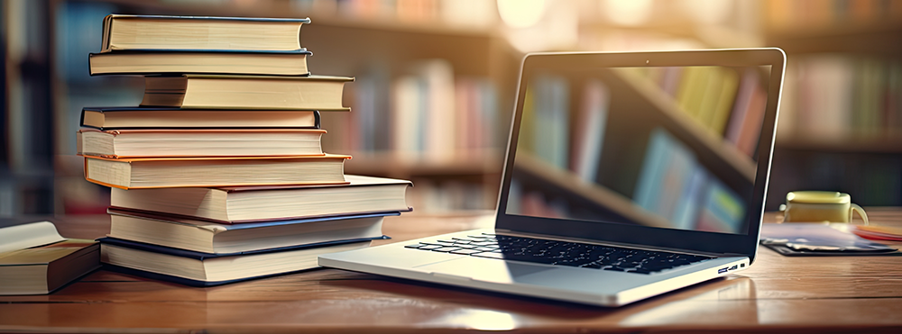 books and laptop sitting on table