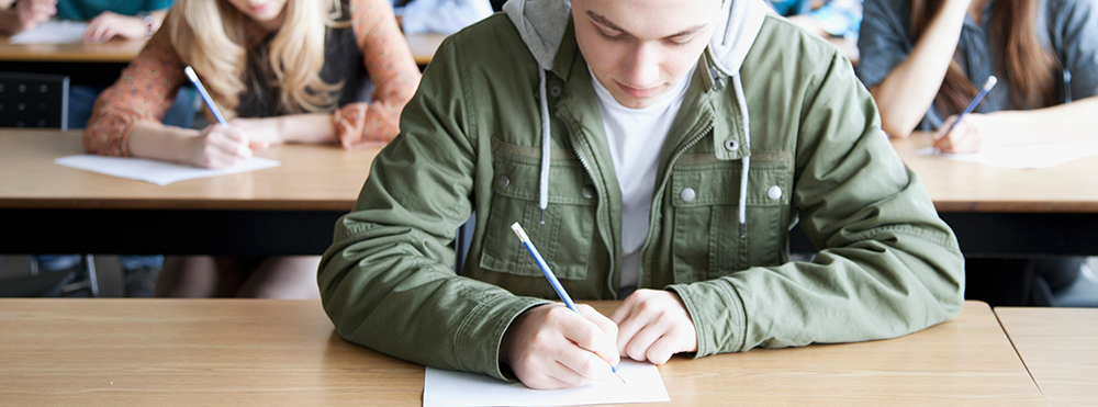 student sitting in class taking test