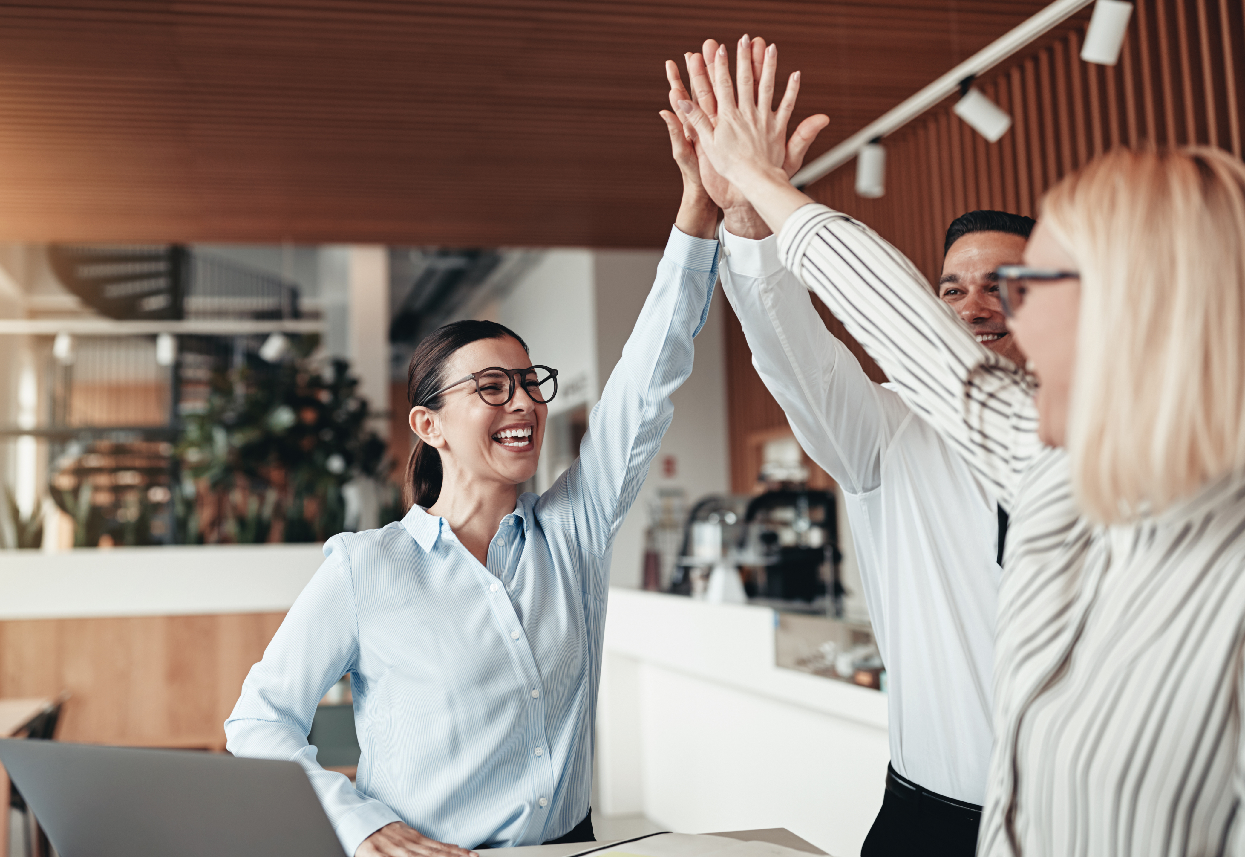 A group of three people giving each other a high five