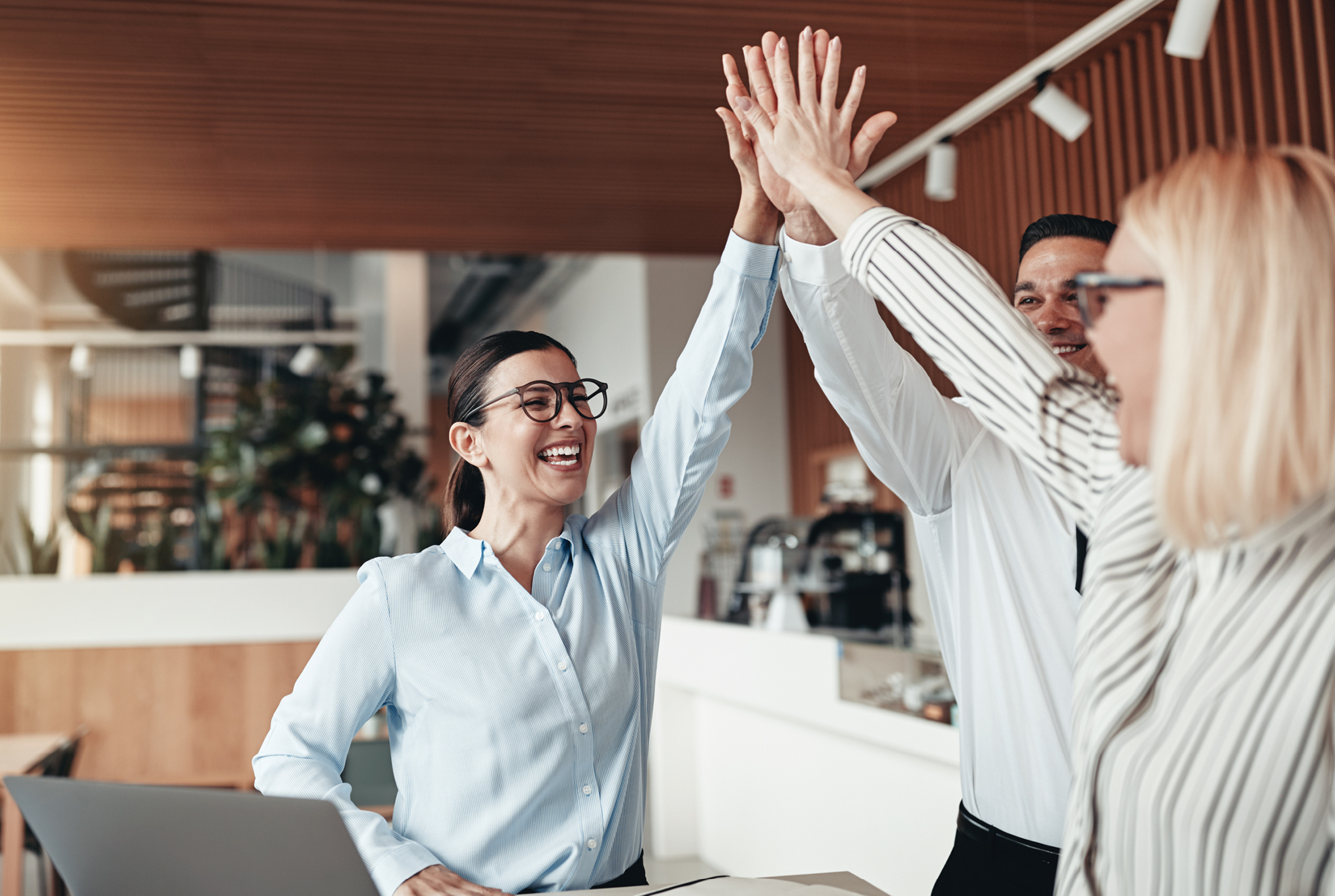 A group of three people giving each other a high five