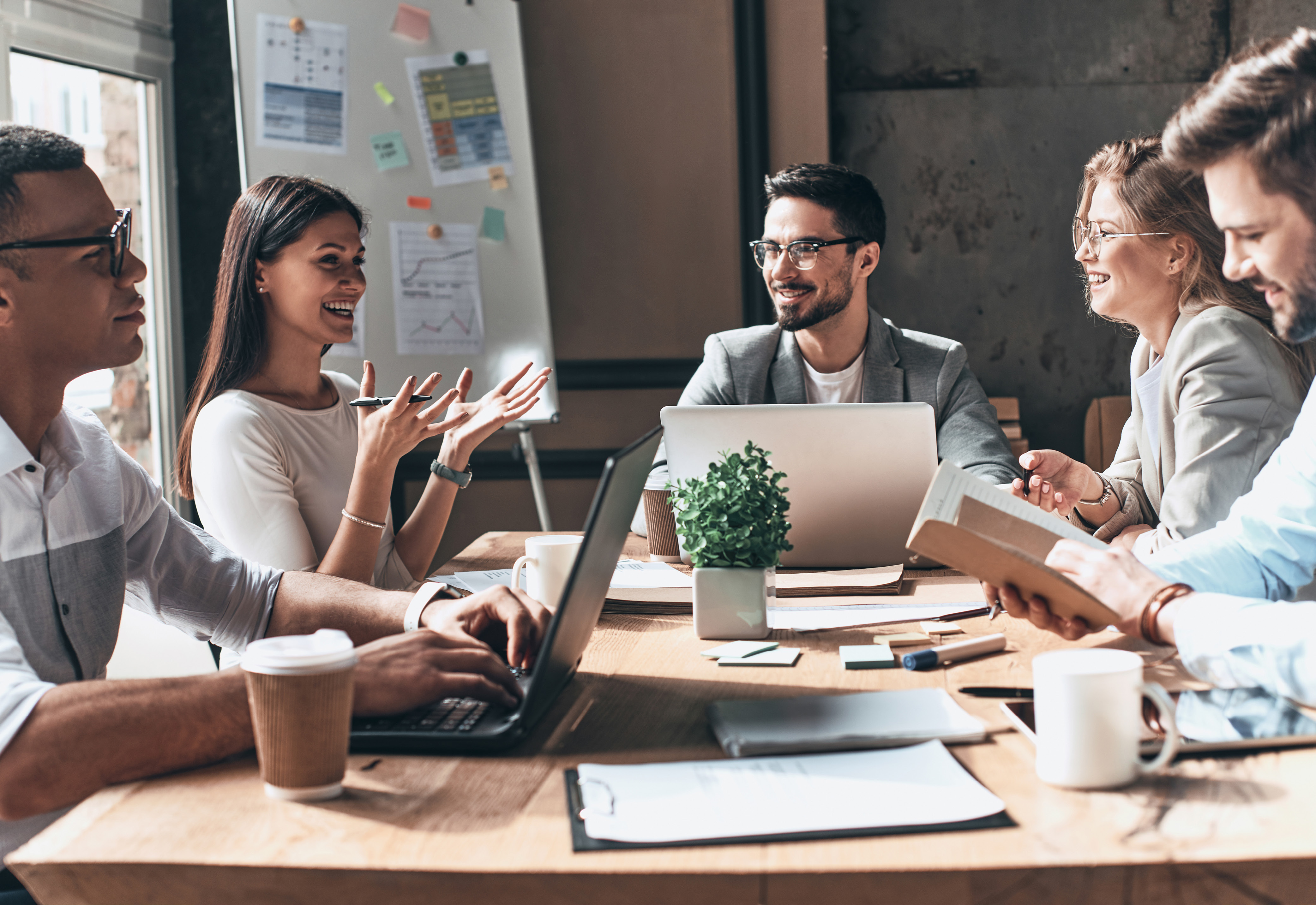 A group of people sitting around a table in an office having a discussion
