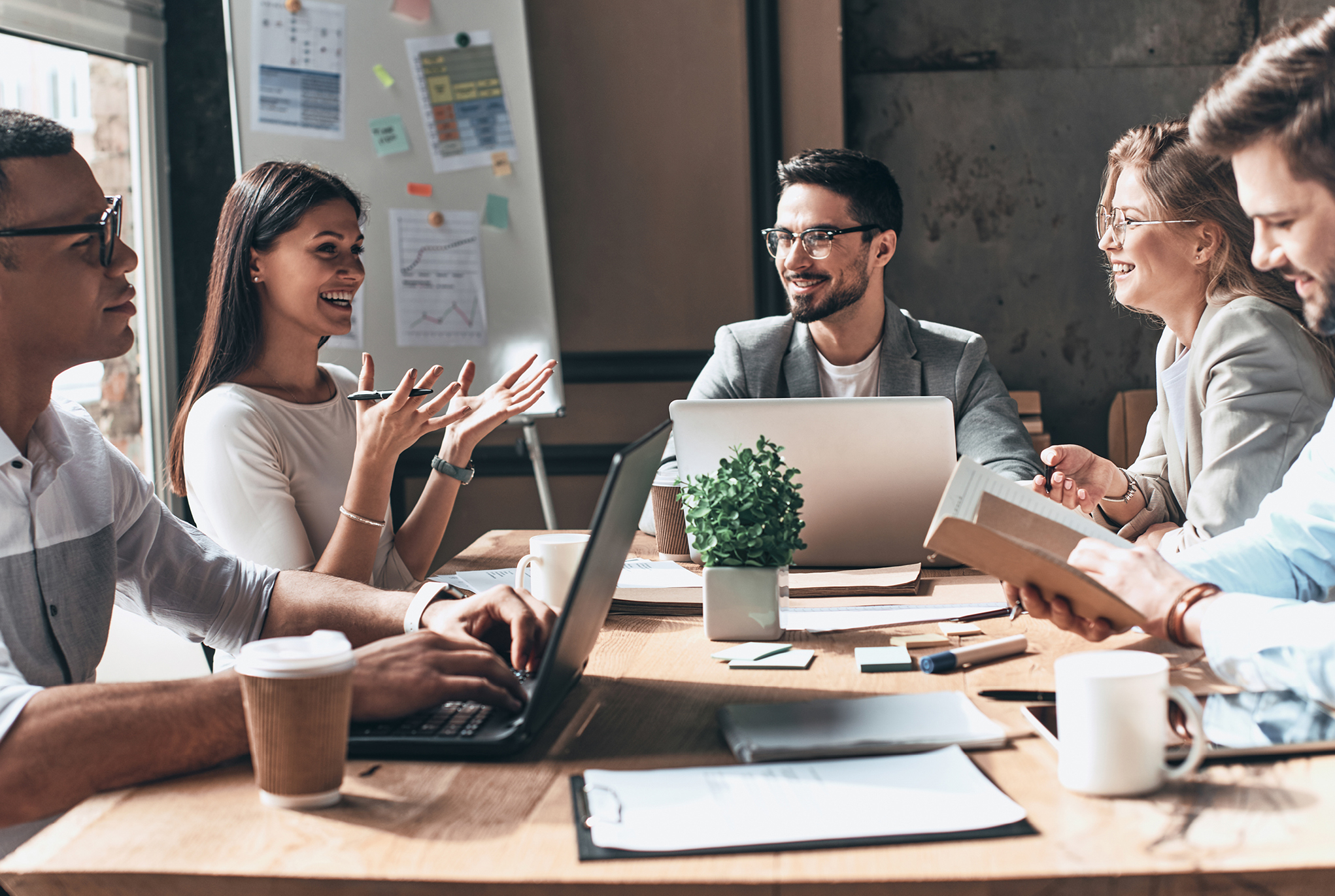 A group of people sitting around a table in an office having a discussion