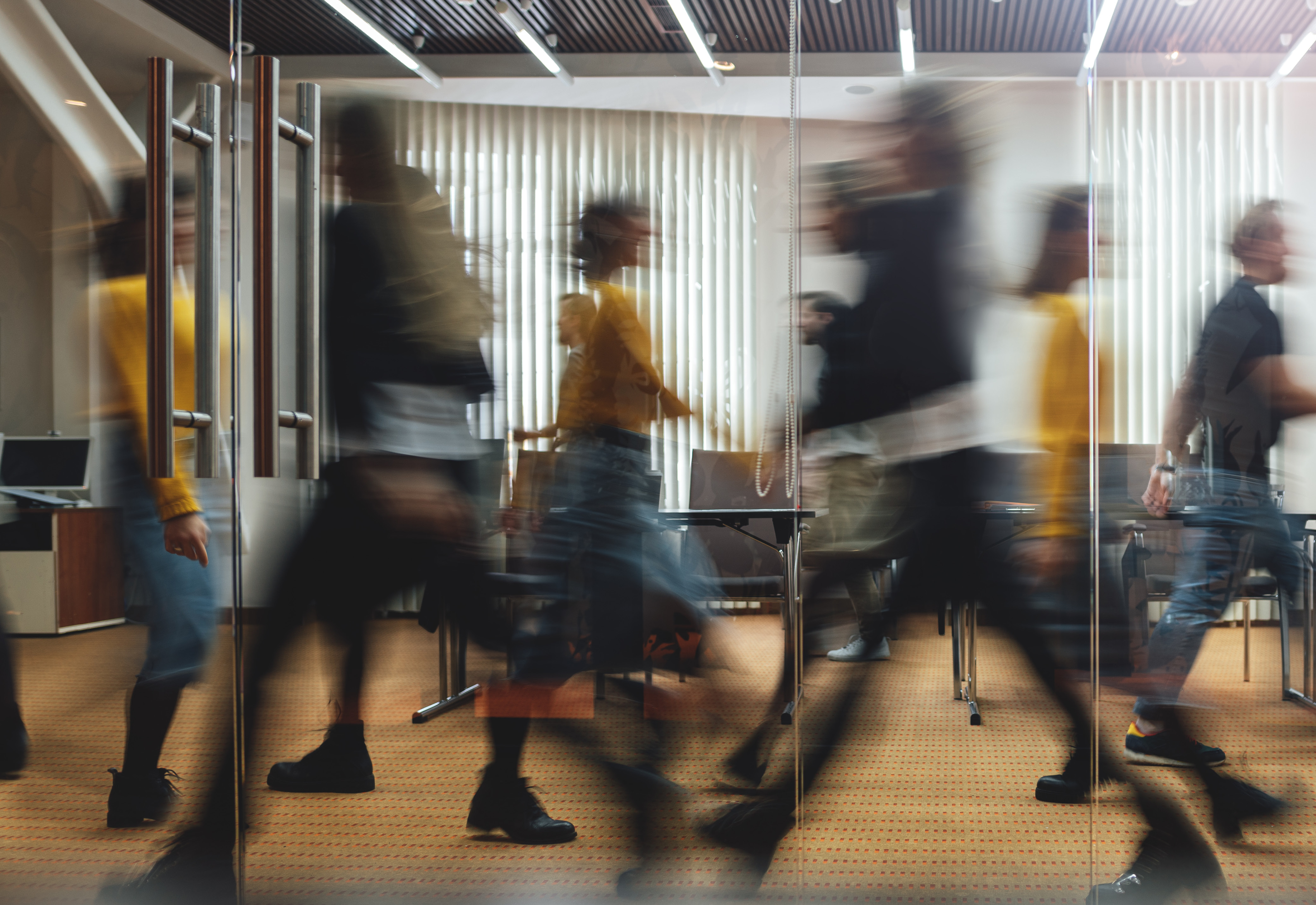 People walking through an office space