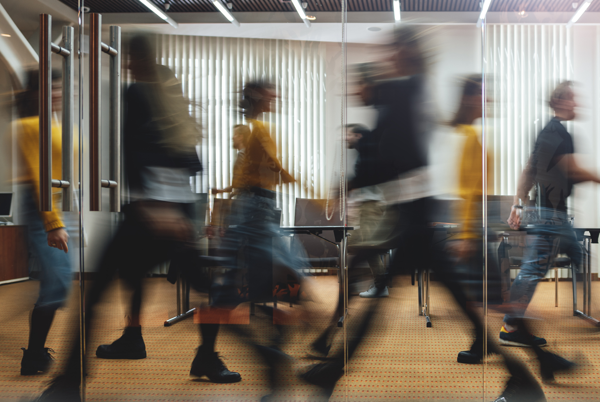 People walking through an office space