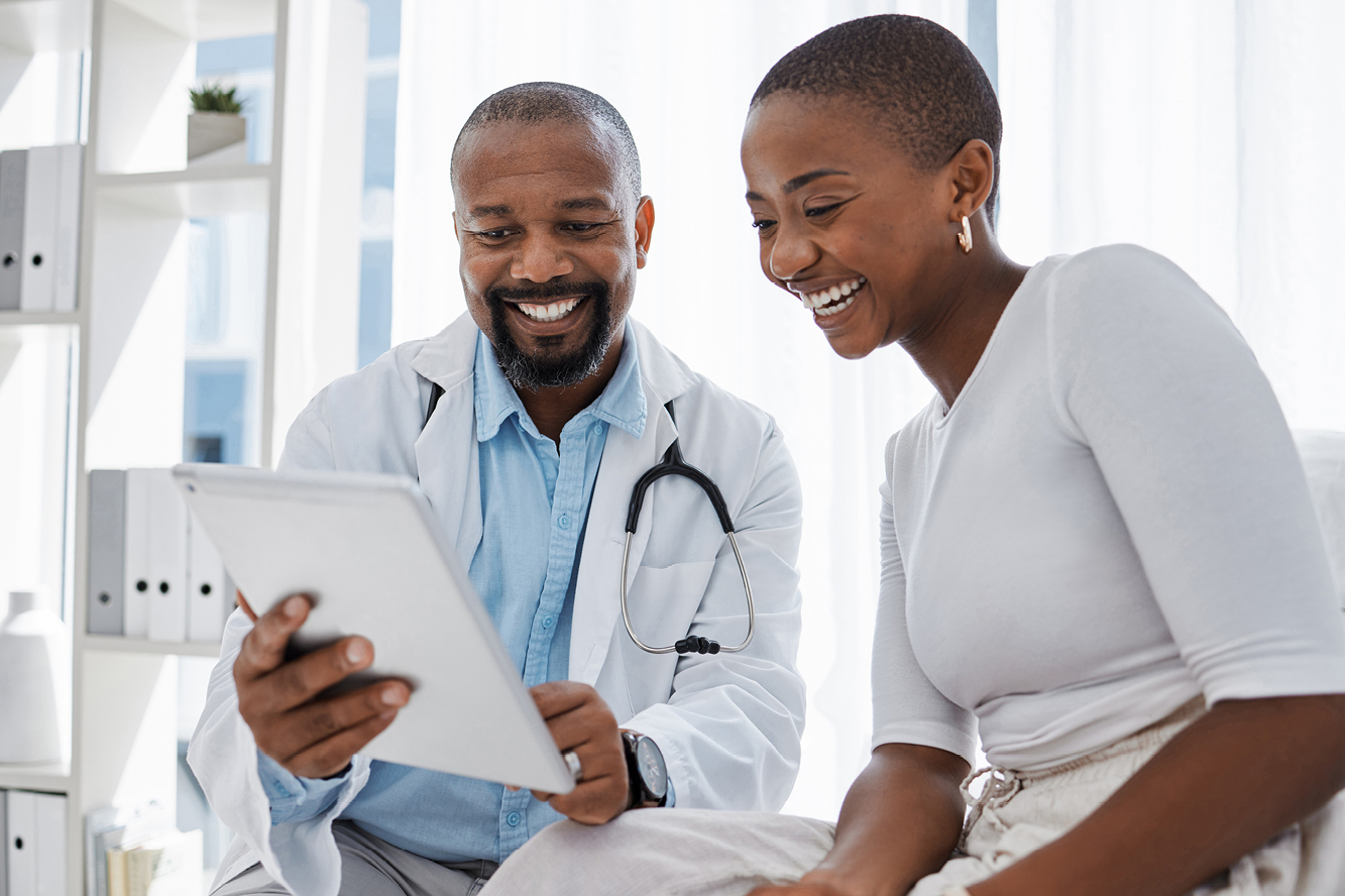 A doctor and a patient sitting together and smiling