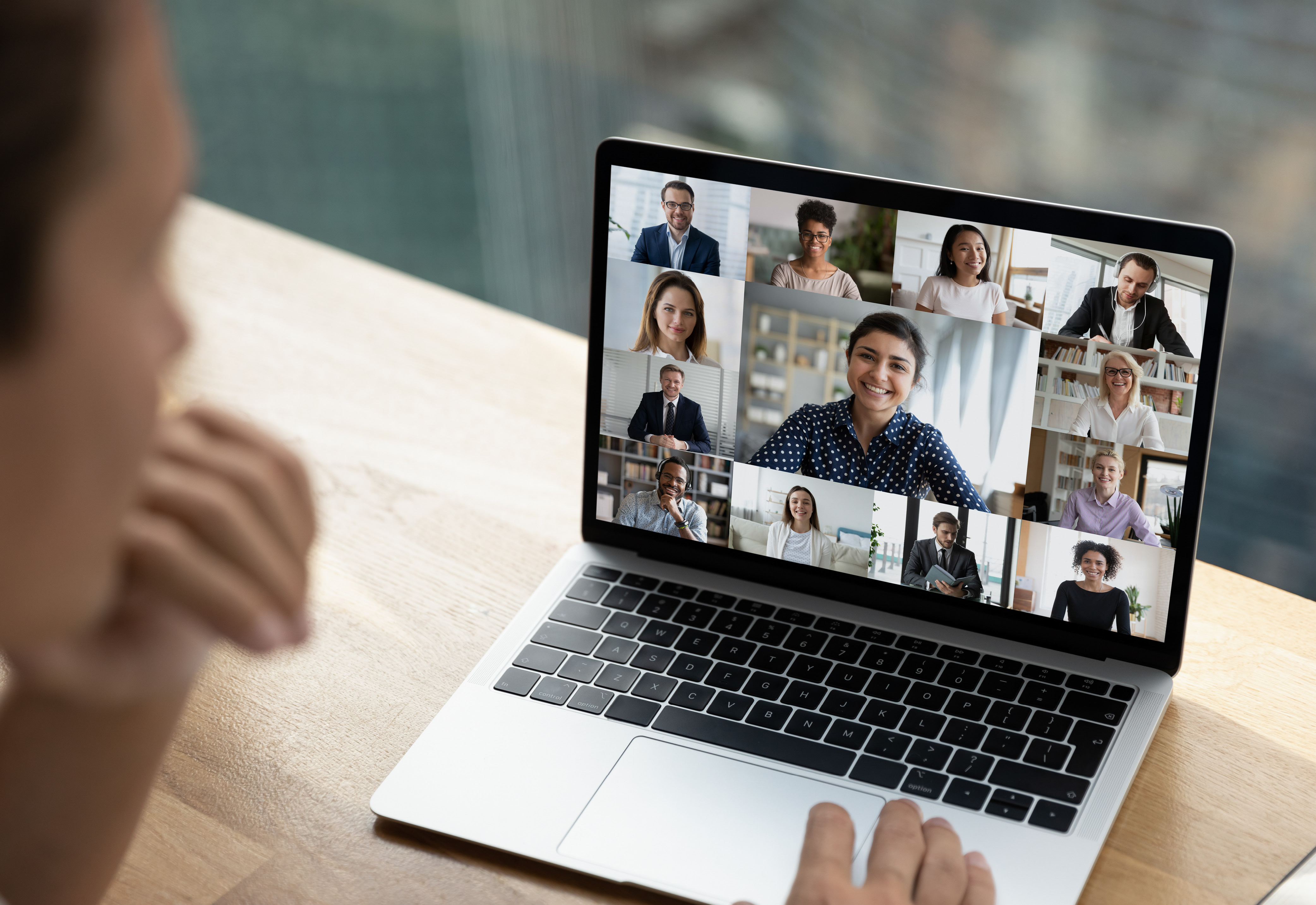 A person in a virtual meeting on their laptop
