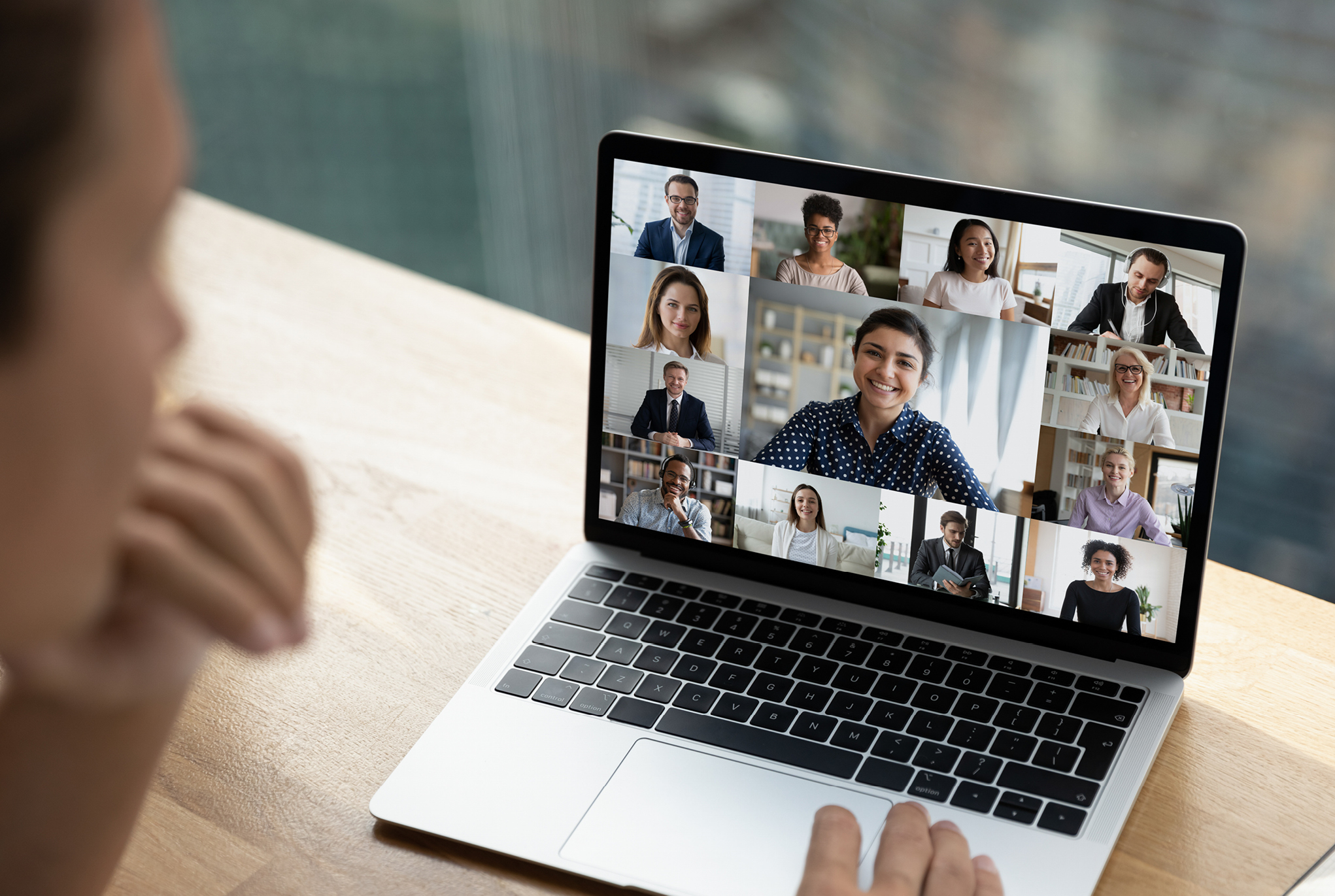 A person in a virtual meeting on their laptop
