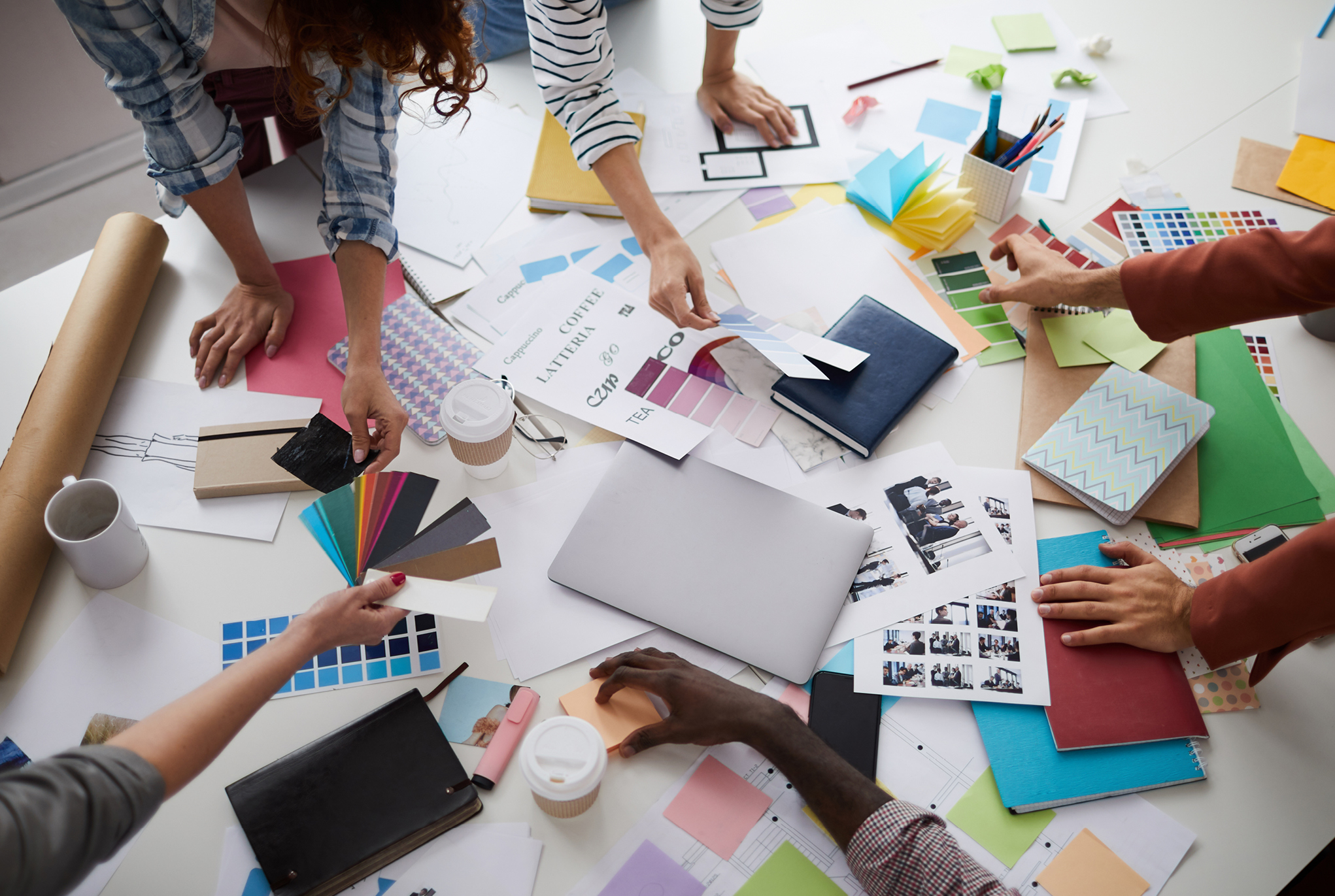 A group of people working on a project with materials scattered around a table
