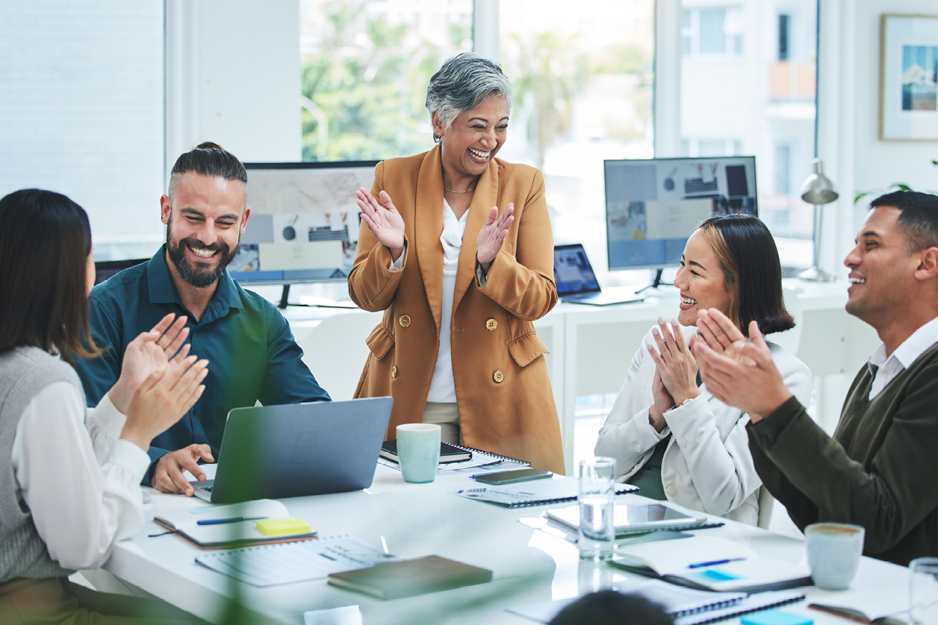 Group of people smiling and clapping