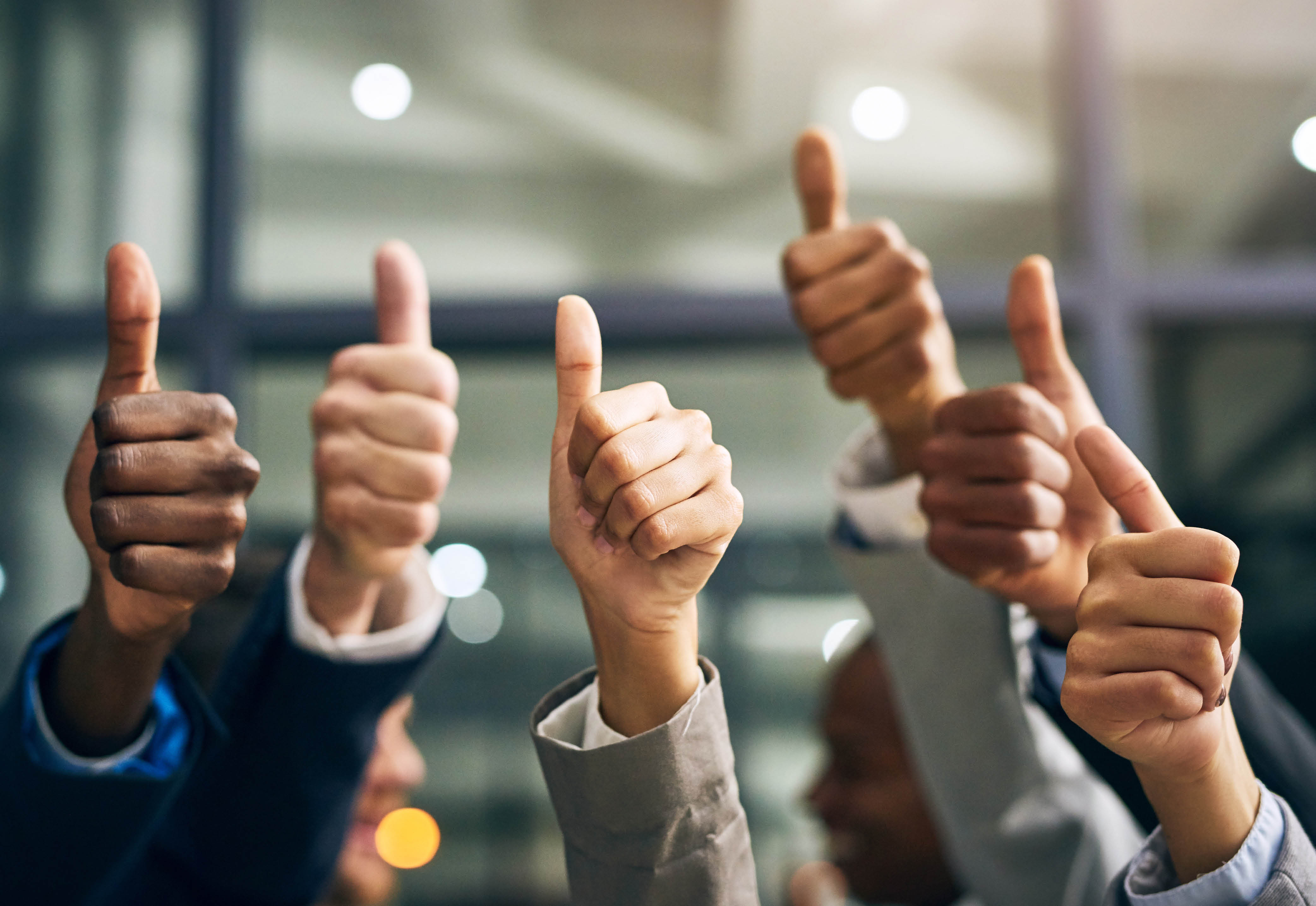 A group of people giving a thumbs up