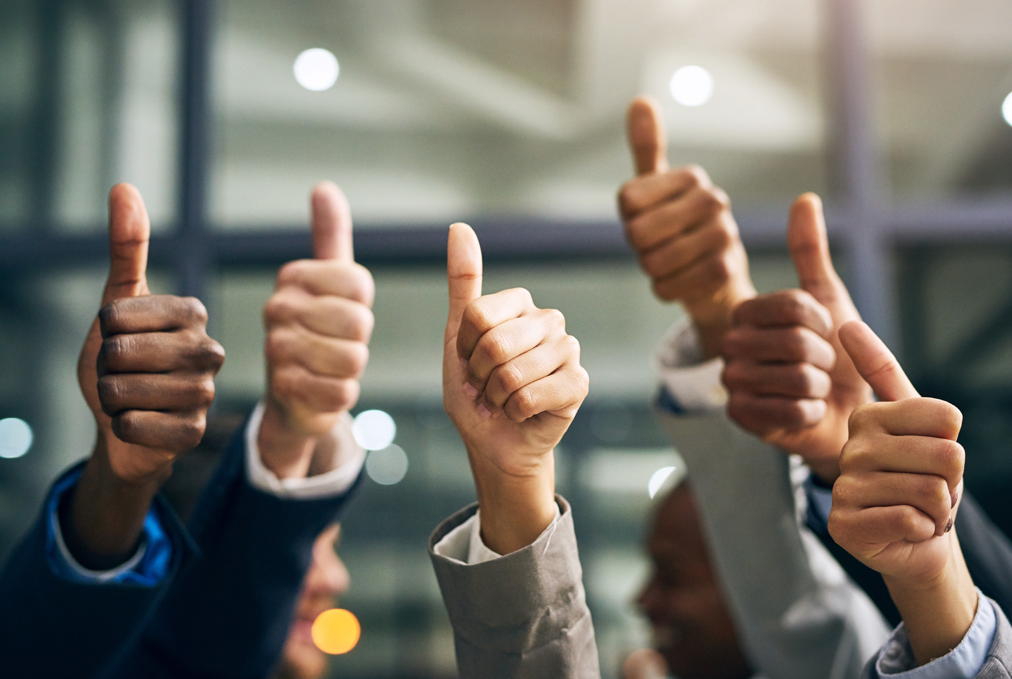 A group of people giving a thumbs up