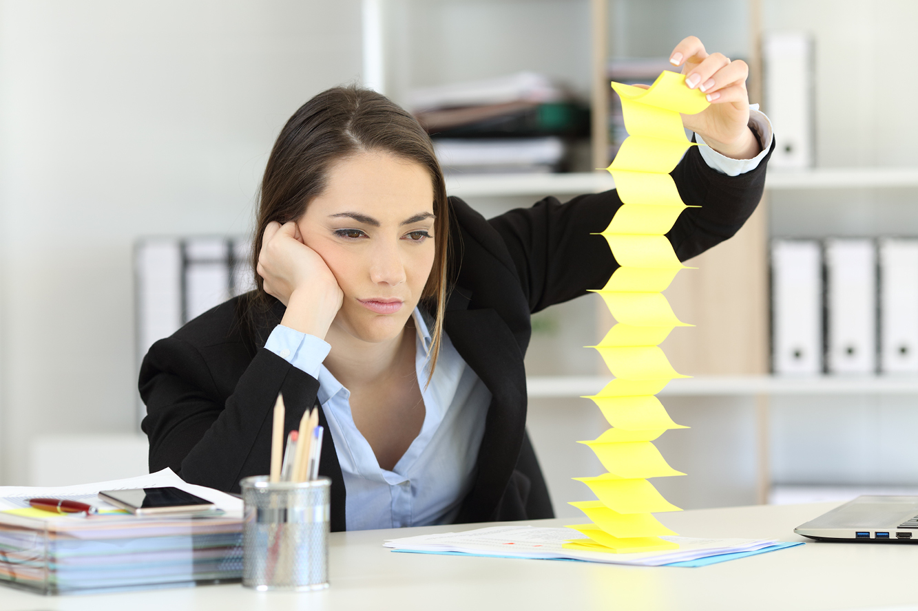 A woman playing with sticky notes at her desk
