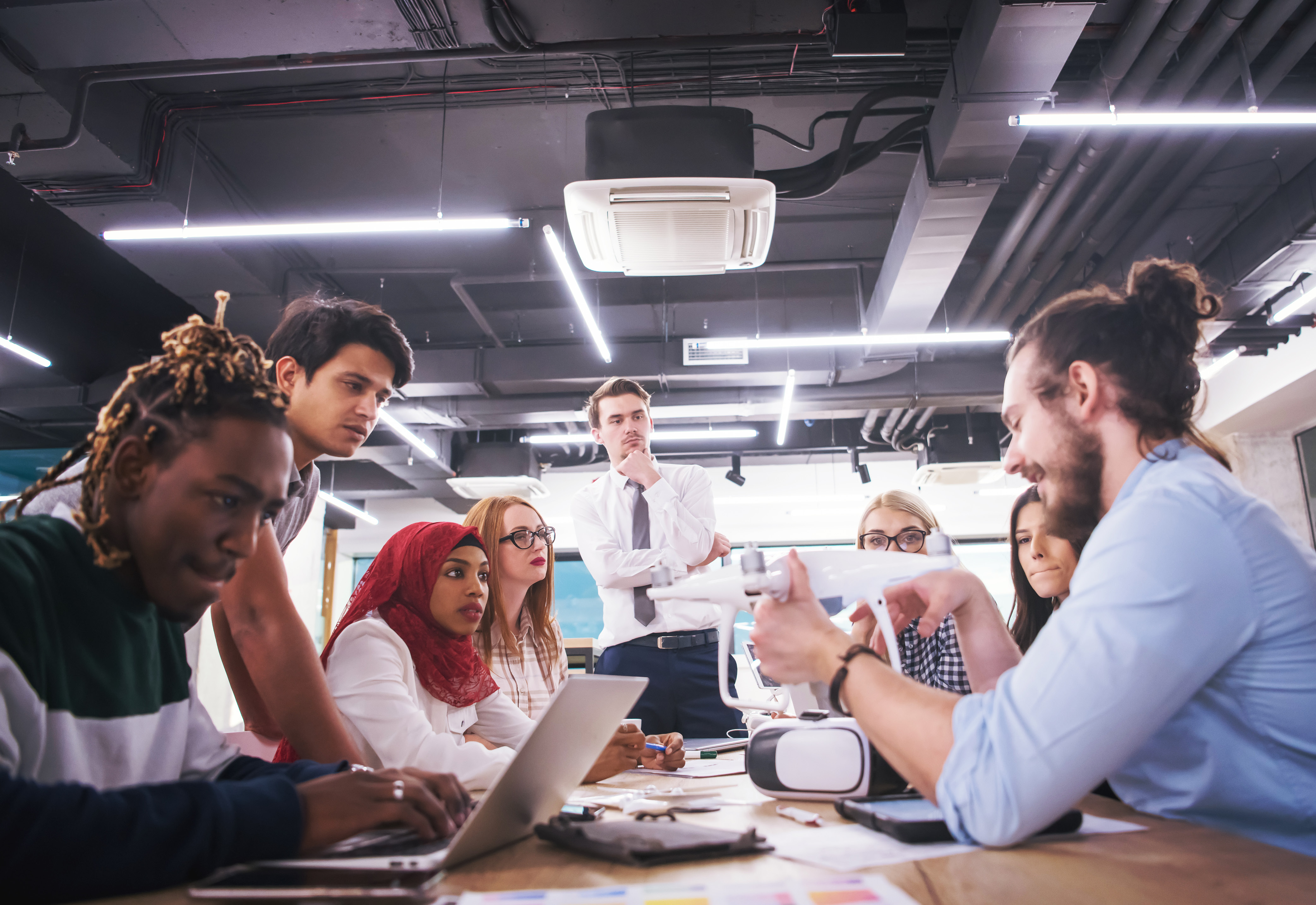 A group of people sitting around a table having a meeting