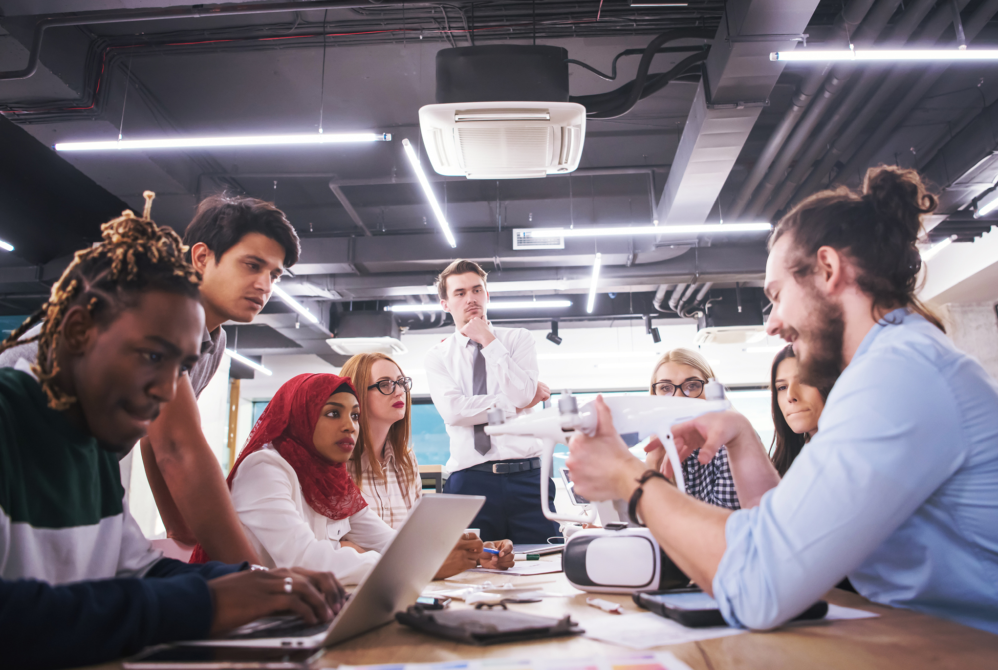 A group of people sitting around a table having a meeting