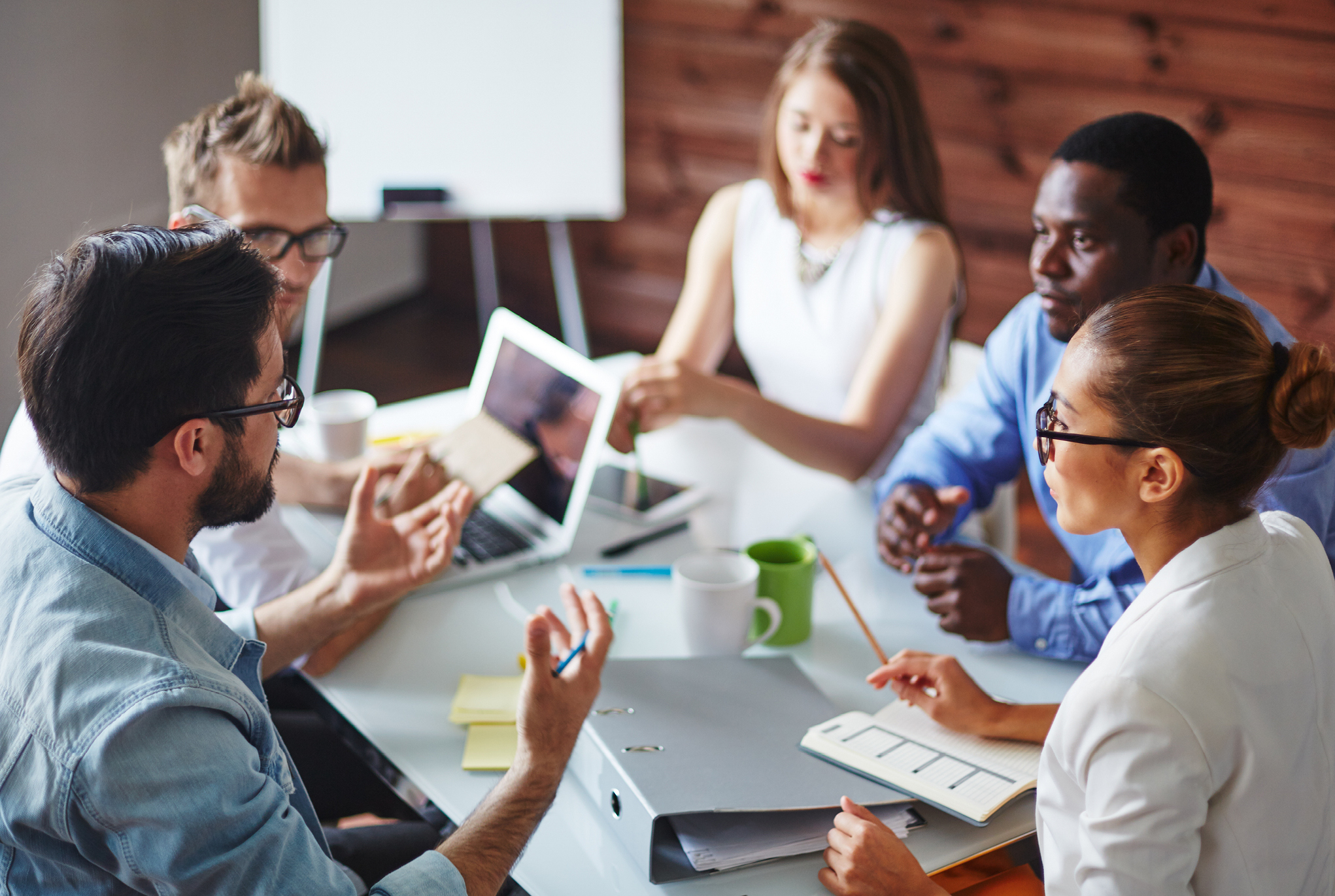 A group of people sitting around a table having a discussion