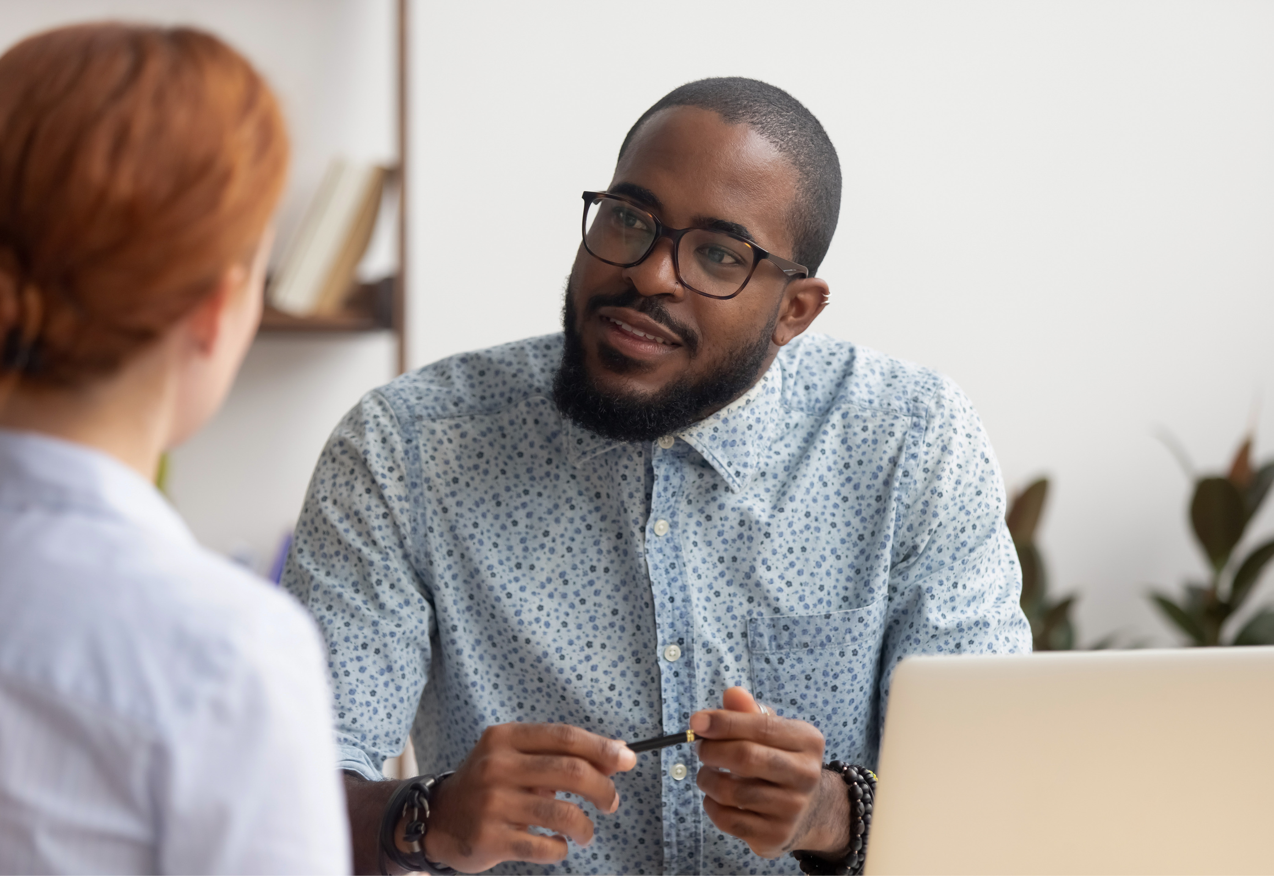 Two people in business attire talking to each other