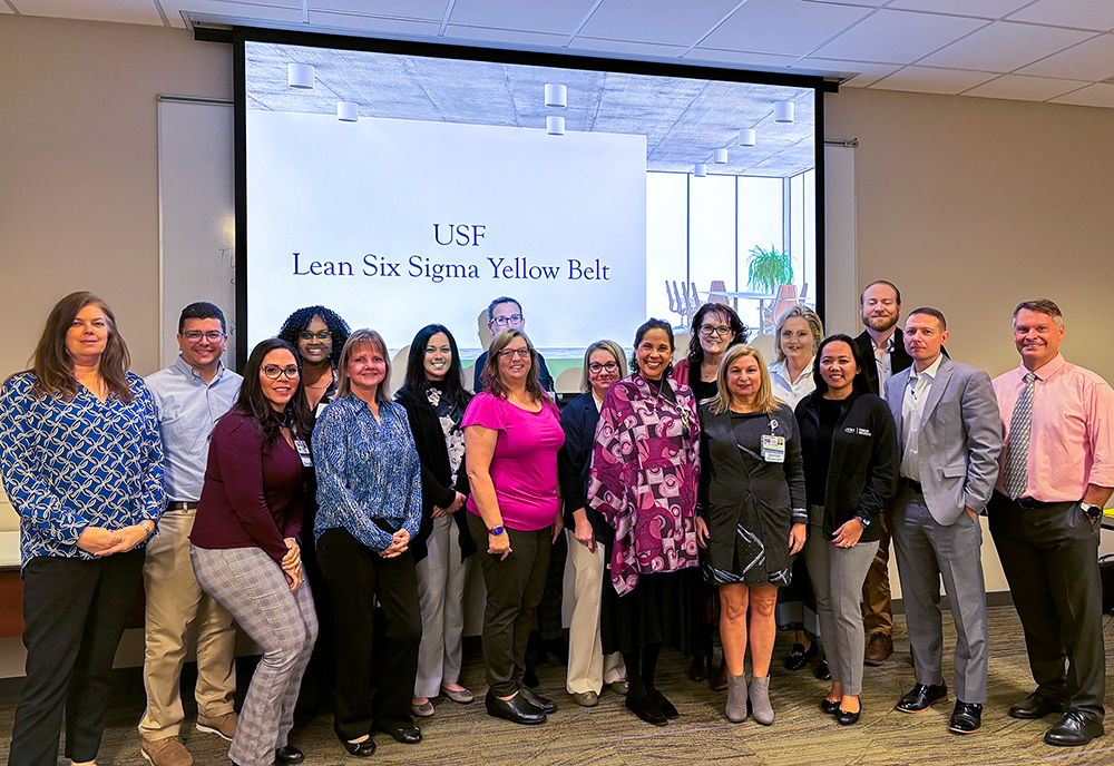 a group of people pose after being awarded with their lean six sigma certification