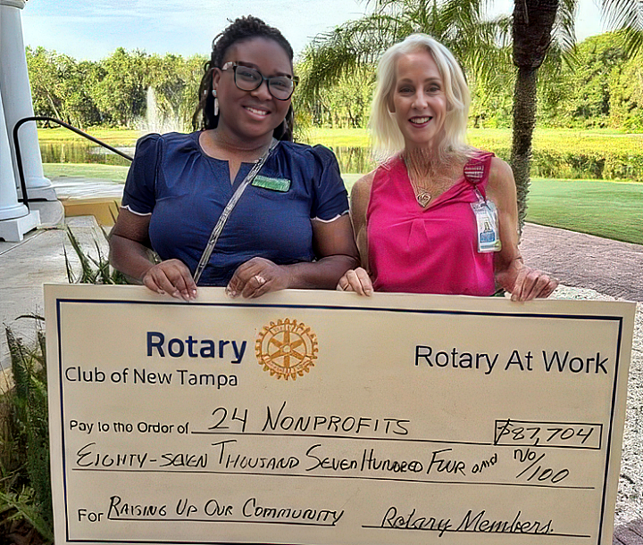Two women with giant check