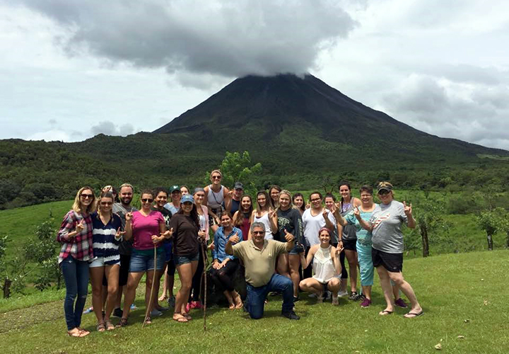 USF Students take a group photo in front of a volcano in Costa Rica