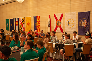 People at a Family event. Students sitting at round tables.