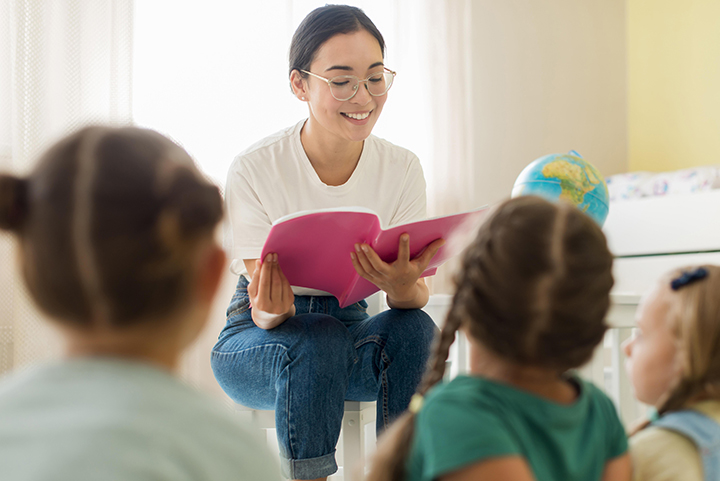 Woman reading to students in a classroom