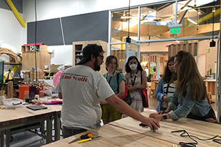 students standing around work table