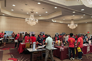 large room with people and posters