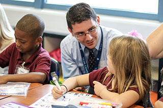 Student Counselor works with a student on a coloring lesson