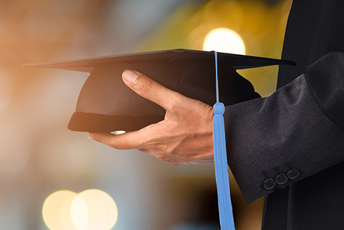 Person holding graduation cap