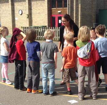 Teacher instructing students during recess