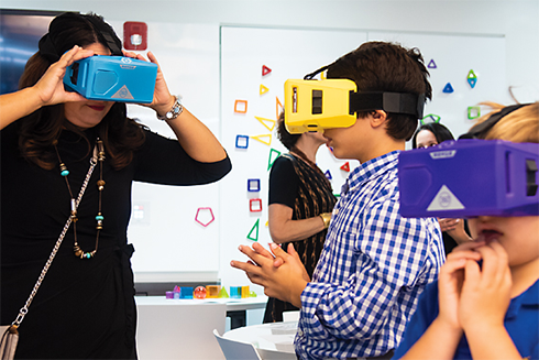 Teacher and students using VR googles in a lab