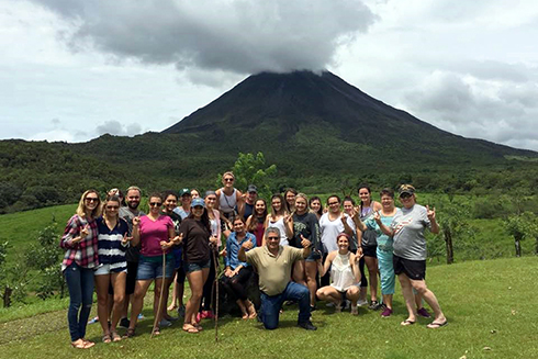 USF students standing in front of a volcano in Costa Rica