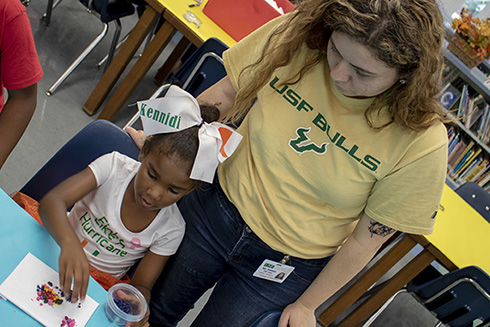 USF student working with an elementary school student at Potter Elementary