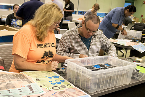 Teachers building a robot at VEX Robotics workshop