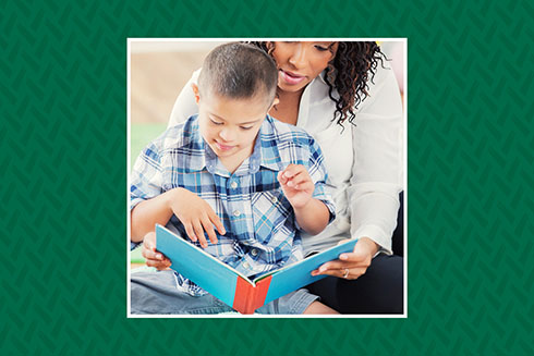 Teacher reading a book with student with disabilities