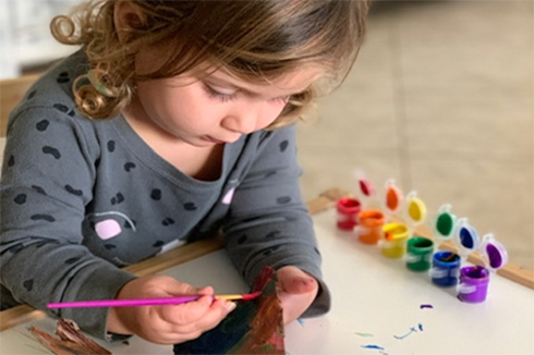 Preschooler painting at home