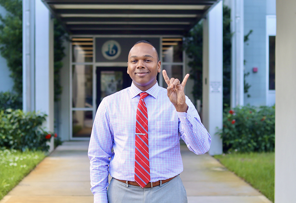 Robert Bhoolai standing outside his school