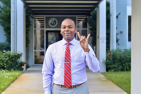 Robert Bhoolai standing outside his school