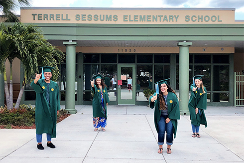 USF graduates standing outside Sessums Elementary