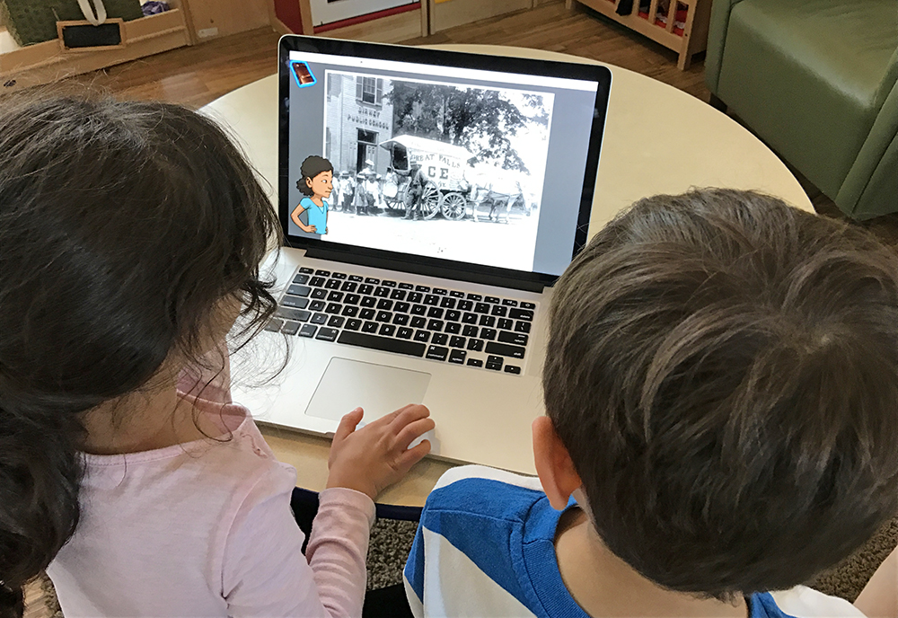 Children using a laptop to access the KidCitizen website.
