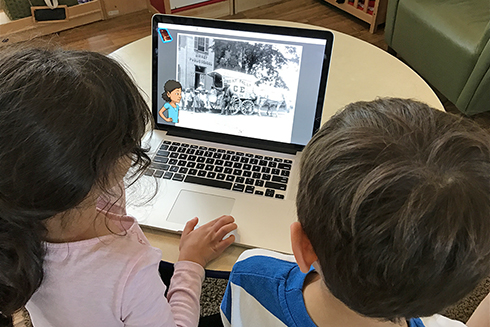 Children using a laptop to access the KidCitizen website.