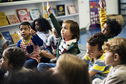 Kids sitting on the floor of a preschool classroom