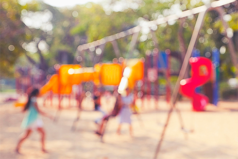 Out of focus image of children playing at playground