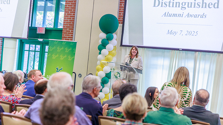 Interim Dean Jenifer Jasinski Schneider speaking on stage at the 2025 Alumni Awards