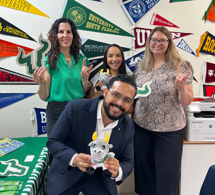 Dinorah Martinez-Tyson and Molly Hamm-Rodriguez of USF, with Dania Gell and Manuel Rodriguez of EducationUSA, showing USF spirit.
