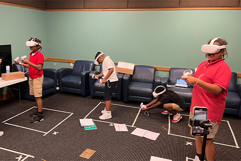 Fourth and fifth graders using virtual reality headsets to analyze video games and learn how to create their own. | Photo by: Leah Burger, USF doctoral student