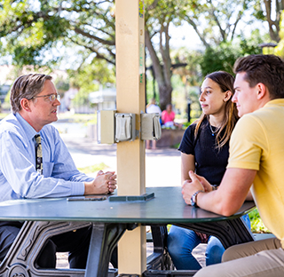 Faculty and students discussion at table