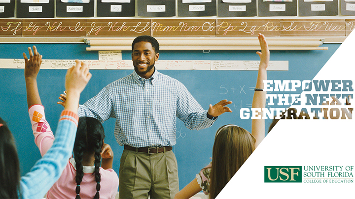 Teacher in classroom with students raising hands