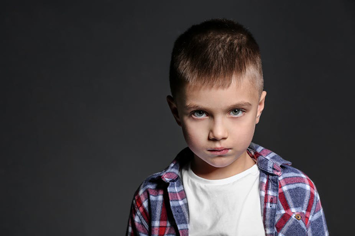 Young child in front of gray background